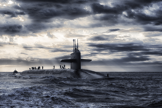 Submarine on top of ocean with sailors on deck